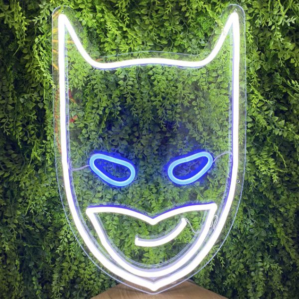 Batman neon light sign shown on green wall - photos from Custom Neon (formerly Neon Collective)