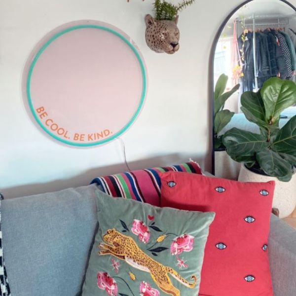 Be Cool Be Kind Mint Pink & Orange Neon Art shown turned off, wall mounted above a sofa @customneon Signs of Change charity range