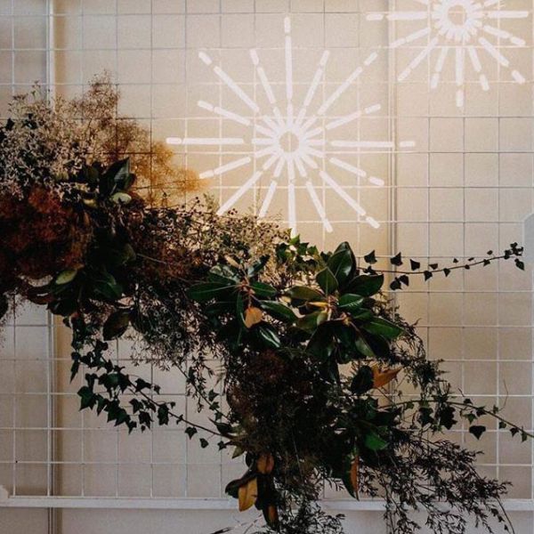Christmas Star LED Neon Light shown on a frame with seasonal florals - from Custom Neon by Neon Collective