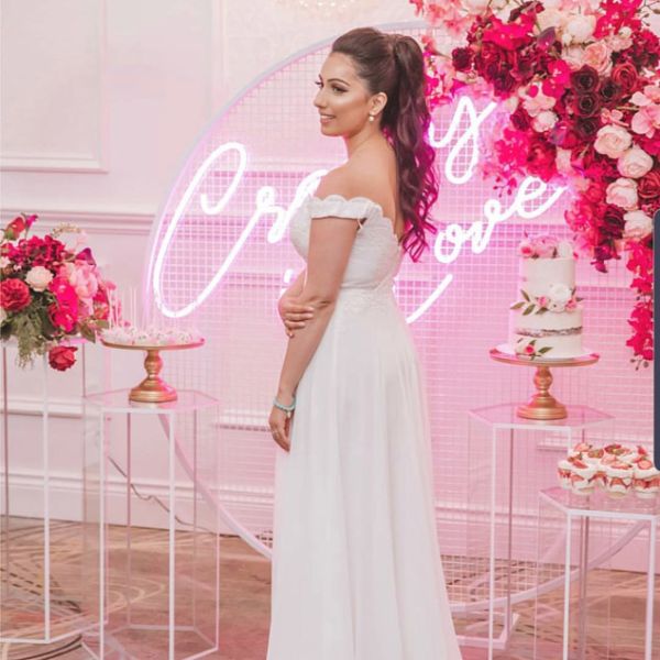 Crazy In Love Wedding Sign in brilliant LED neon flex shown in pink with the beautiful bride, wedding florals and cakes - photo from Custom Neon @customneon
