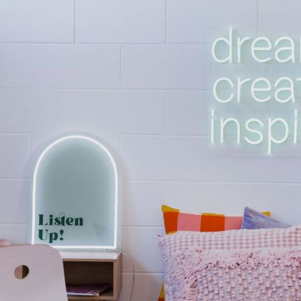 Listen Up! white & green neon art shown as a desk light in a dorm room @customneon Signs of Change charity range