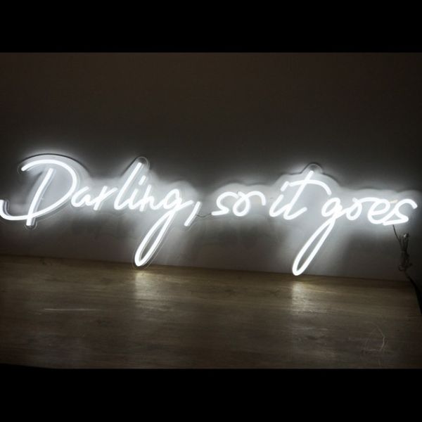 Darling, so it goes LED neon flex sign shown on a wooden table - photo from Custom Neon by Neon Collective