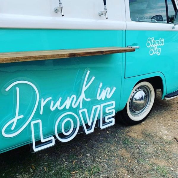 Drunk in LOVE LED Neon Light Sign for Weddings, Bars & Home Decor shown on bar van at an event  - photo Custom Neon by Neon Collective