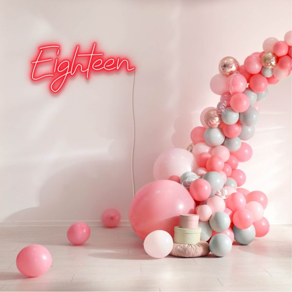 Eighteen Light Sign shown in red with a balloon arch and presents |  Custom Neon®
