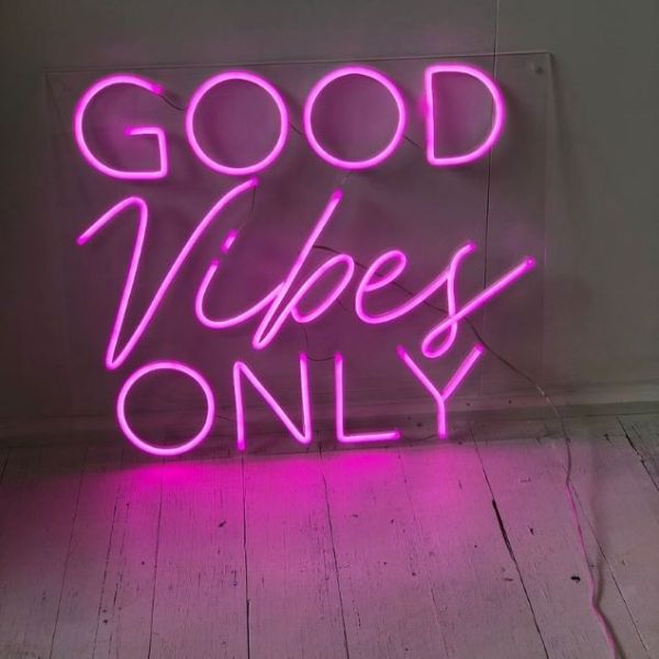 Good Vibes Only neon sign in pink shown  illuminated - from Custom Neon®