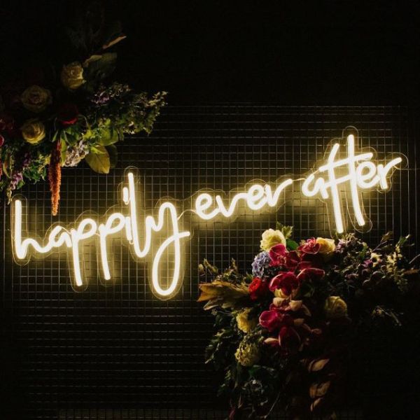 Happily Ever After LED neon sign surrounded by floral decorations - from Custom Neon®