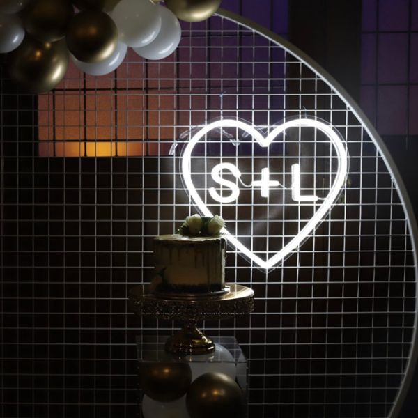 Personalized Heart Neon Sign in LED Flex with clear acrylic background displayed with balloons and wedding cake - photo CustomNeon.com.au