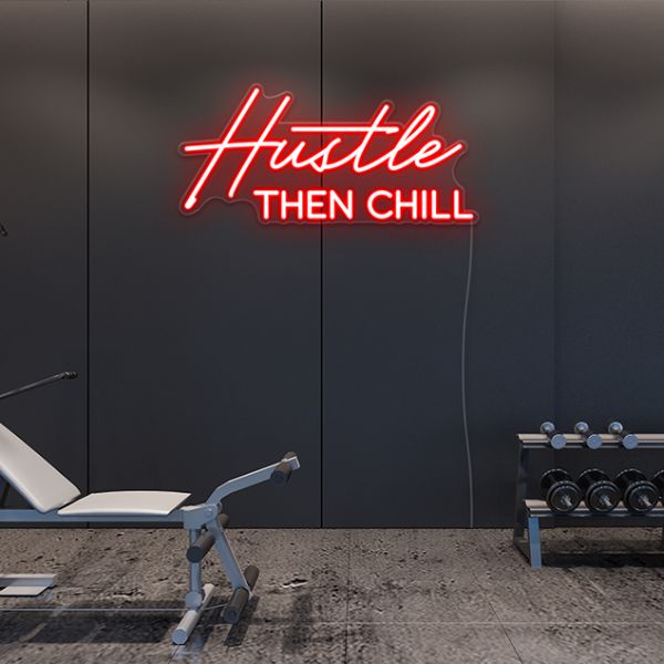 Red Hustle Then Chill light sign wall mounted in a fitness studios by CUSTOM NEON®
