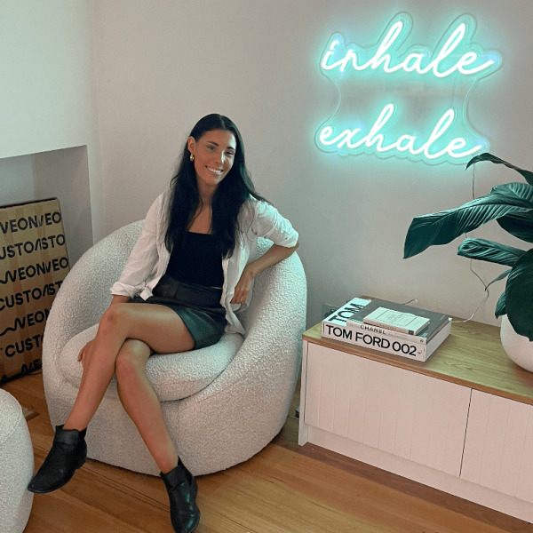 Inhale Exhale Custom Neon® wall sign shown illuminated on a white wall