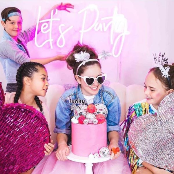 Let's Party LED neon sign shown at a tweens birthday party - from Custom Neon® @customneon