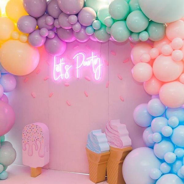 Let's Party portable LED neon sign shown on the photo wall of a kids party - made by @customneon for @zbyzahrah