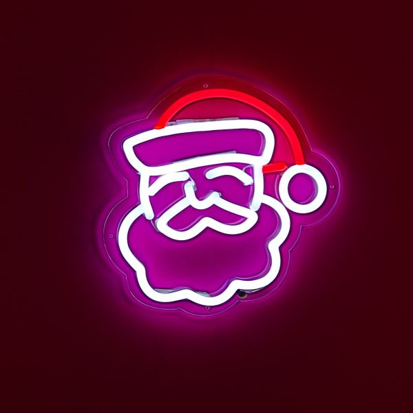 CUSTOM NEON® Light Up Santa shown illuminated against a dark pink wall
