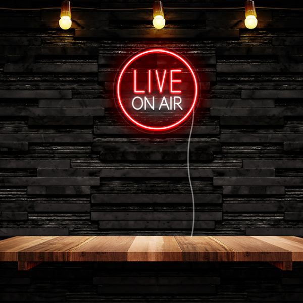 CUSTOM NEON® Live on Air recording studio sign shown in red and white mounted on a black stone wall