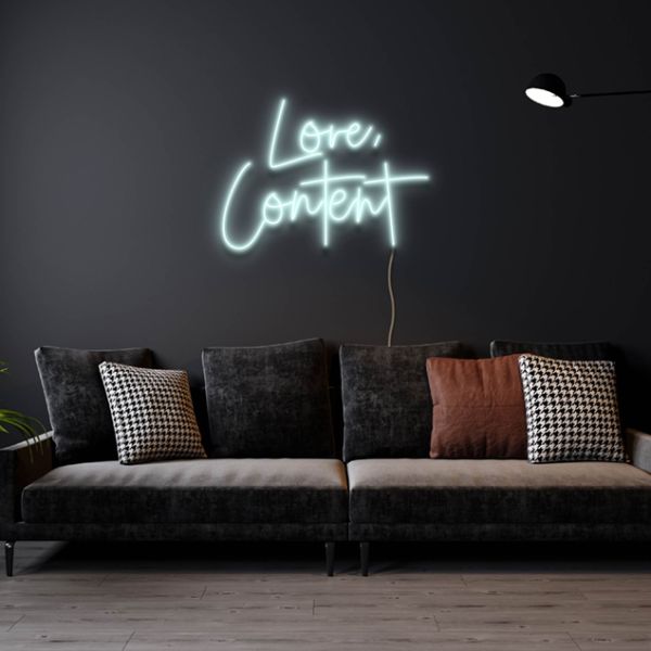Love, Content white faux neon sign wall mounted above a sofa - design by Custom Neon