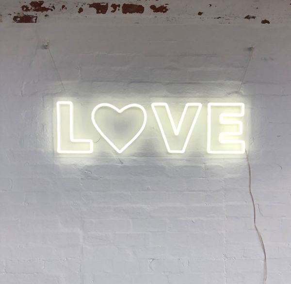 Love LED Neon Letter Light mounted on brick wall
 - photo from Custom Neon by Neon Collective