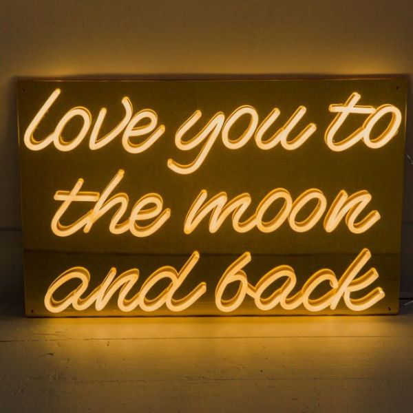 Love You To The Moon and Back warm white LED neon on gold mirrored acrylic backboard shown in dim light - CUSTOM NEON®