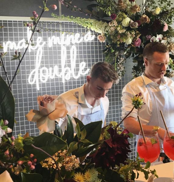 Make Mine a Double trendy LED neon bar sign behind the open bar at an event  - photo from CustomNeon.com