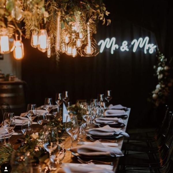 Mr & Mrs light sign at the head of the top table at a wedding - from Custom Neon