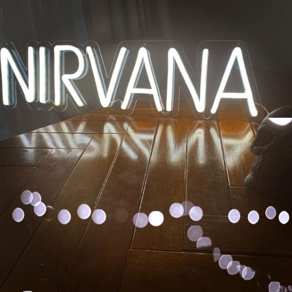 Nirvana white LED neon sign shown on a table - from Custom Neon