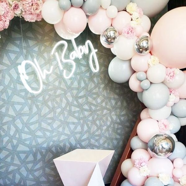 Oh Baby trendy baby shower sign shown surrounded by balloons - photo from Custom Neon by Neon Collective