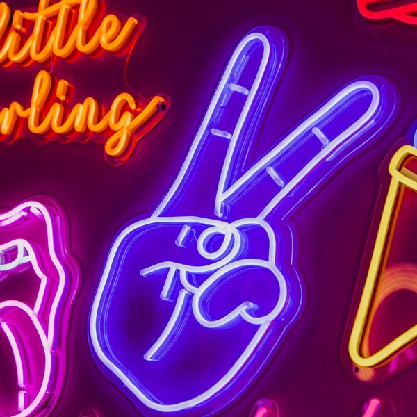 Custom Neon® blue peace hand LED neon light shown illuminated against a dark background in dim light