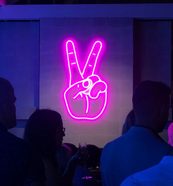 Neon Peace Sign aesthetic neon light shown wall mounted in a restaurant in Geelong, Australia - photo from Custom Neon by Neon Collective
