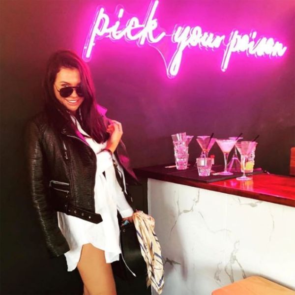 Pick Your Poison LED Neon Bar Sign shown above the bar at a party - from CustomNeon.com.au