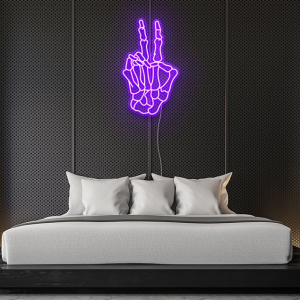 Skeleton hand peace sign in purple LED neon flex shown as bedroom wall décor - by Custom Neon®.