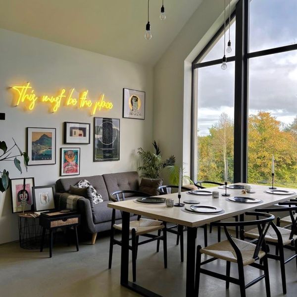 This Must be the Place yellow Custom Neon® sign on a feature wall in a living/dining room @our_build_our_journey