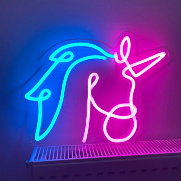 Custom Neon® Unicorn Line Art shown in pink and blue on a dark background in dim light