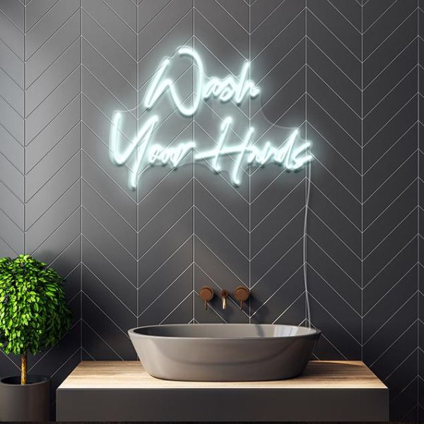 Wash Your Hands white CUSTOM NEON® sign above sink in a bathroom