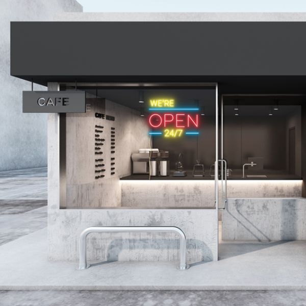 WE'RE OPEN 24/7 in brilliant yellow and red, with bright blue lines shown in a cafe window - from CustomNeon.com.au