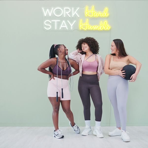 Work Hard Stay Humble in white & yellow on moss colored wall - by CUSTOM NEON®