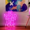 Be Naked When I Get Home LED neon sign shown on the floor beneath a painting - photo from CustomNeon.com.au