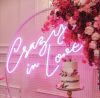 Crazy In Love Wedding Sign in brilliant LED neon flex shown in pink with wedding florals and cakes - photo from Custom Neon @customneon
