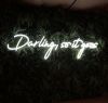 Darling, so it goes Neon Sign Quote for Weddings & Home Decor shown on green wall
 - photo from Custom Neon by Neon Collective