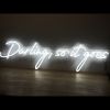 Darling, so it goes LED neon flex sign shown on a wooden table - photo from Custom Neon by Neon Collective