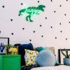 Personalised name sign in LED neon with dinosaur background shown in child's room - from Custom Neon by Neon Collective