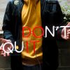 Don't Quit / Do It red and white neon sign held by a man @customneon