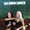 * Eat Drink Dance * Portable LED Neon Light Sign shown on a green wall at an Event - photo from CustomNeon.com.au