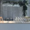 EAT DRINK DANCE neon flex sign shown behind a pop up event bar - photo from CustomNeon.com.au