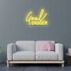 Goal Digger pre-designed CUSTOM NEON® word sign shown in yellow wall mounted above a sofa