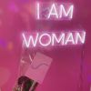 I Am Woman white Custom Neon® sign on pink wall