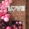 Beautiful, modern neon letter lights spelling the word LOVE with a heart for the O
 - photo from Custom Neon by Neon Collective
