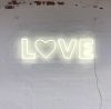 Love LED Neon Letter Light mounted on brick wall
 - photo from Custom Neon by Neon Collective