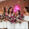 LED neon heart light for wedding decor shown wall mounted in pink with Custom Neon's founder, Jess Munday, and her bridesmaids