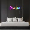 Colorful LED neon One Love word sign shown against a dark wallas bedroom décor - by Custom Neon®