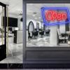 Neon look LED shop open sign in blue and red with an asymmetric outline shown in a hair salon window - from CustomNeon.com.au