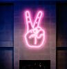 LED Neon Peace Sign Aesthetic Wall Art shown mounted on the wall over a fireplace - photo from Custom Neon by Neon Collective
