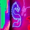 Stylized Chinese Dragon LED neon art from Custom Neon® shown in blue styled on a dark pink background surrounded by neon lights